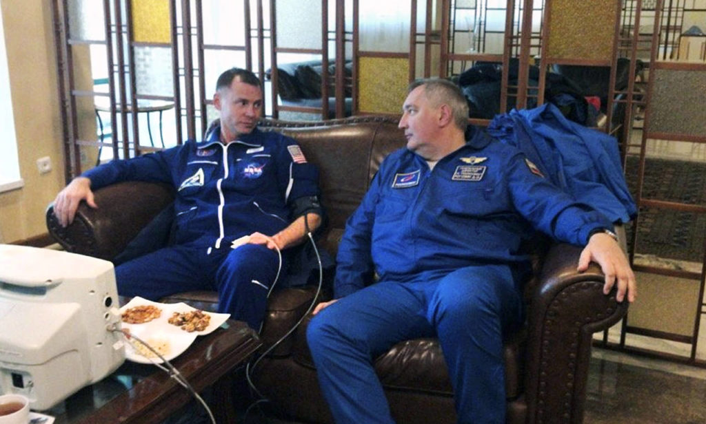 NASA Astronaut Nick Hague (left) and Roscosmos Director Dmitry Rogozin sit in Dzhezkazgan, Kazakhstan on Thursday after an emergency landing following the failure of a Russian booster rocket carrying them to the International Space Station. (Roscosmos via AP)
