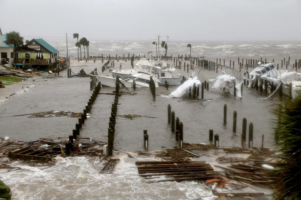 As the storm surge receded, boats lay sunk and damaged at the Port St. Joe Marina in Florida on Wednesday. (Douglas R. Clifford/Tampa Bay Times via AP)
