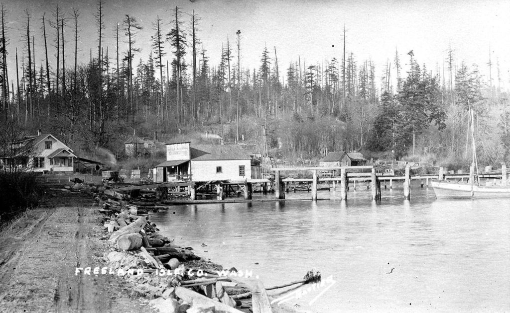 In the early 1900s, Holmes Harbor in Freeland was a hub of businesses established by the Spencer family. Great-granddaughter Betty Discher, a South Whidbey Historical Society Board member and docent, will talk about the beginnings of Freeland during Sunday’s fundraising tour. (South Whidbey Historical Society)
