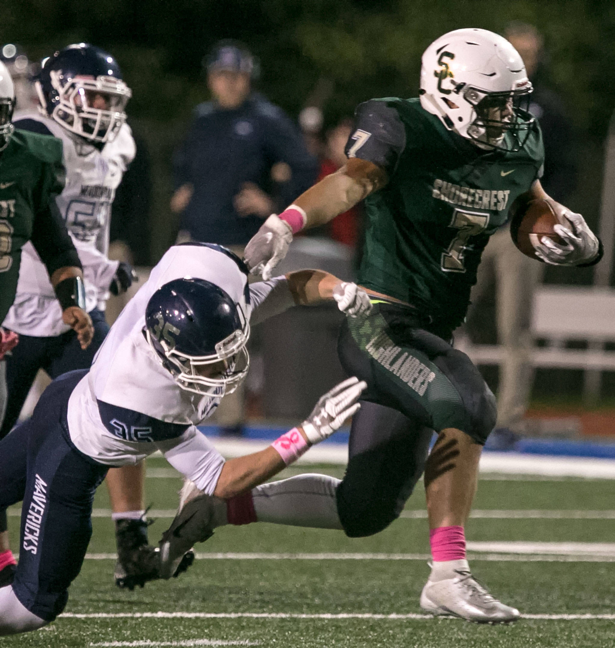 Shorecrests Markus Selzler avoids a tackle by Meadowdales Mason Vaughn on Friday night at Shoreline Stadium. (Kevin Clark / The Herald)