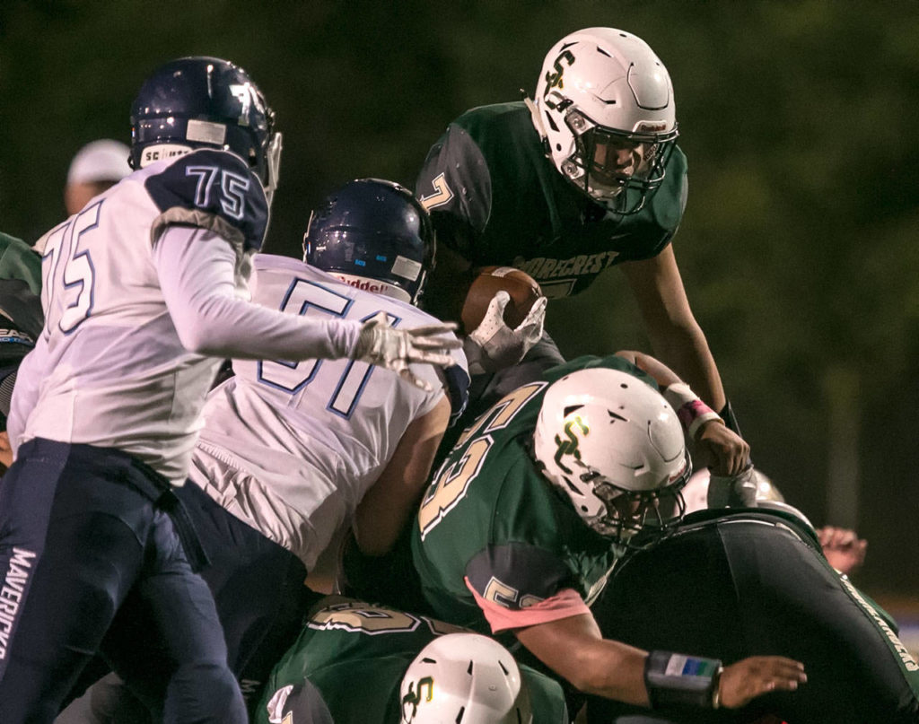Shorecrest’s Markus Selzler attempts to leap the pile against Meadowdale on Friday night at Shoreline Stadium. (Kevin Clark / The Herald)
