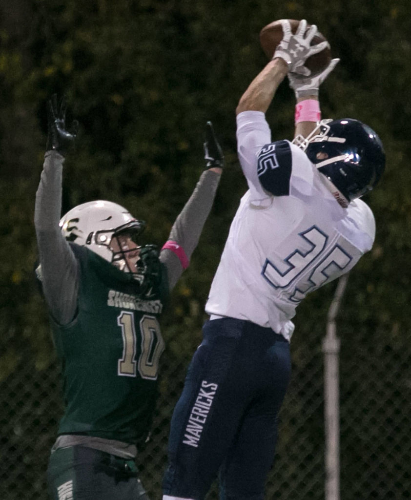 Meadowdale’s Mason Vaughn catches a pass with Shorecrest’s Logan Stoecker defending Friday night at Shoreline Stadium. (Kevin Clark / The Herald)
