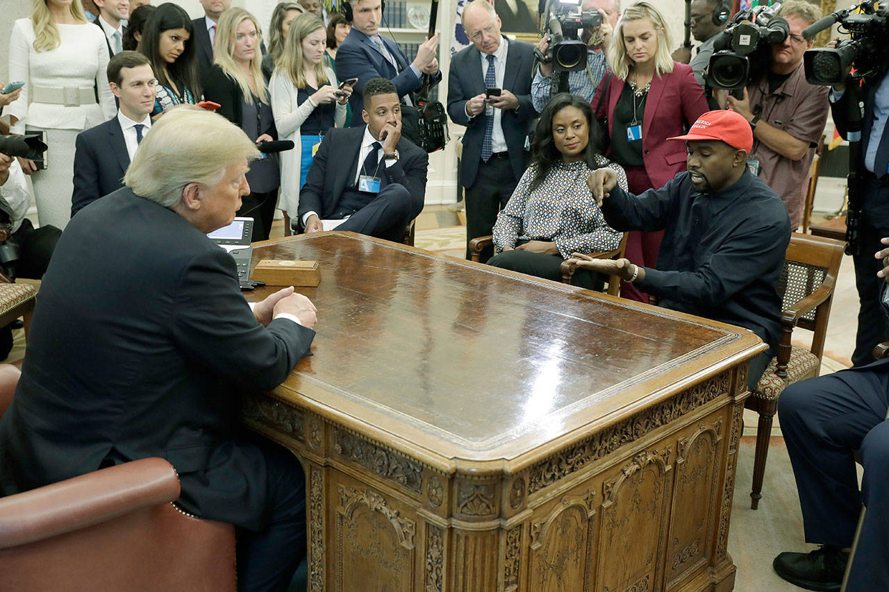 Rapper Kanye West speaks to President Donald Trump and others Thursday in the Oval Office of the White House. (AP Photo/Evan Vucci)