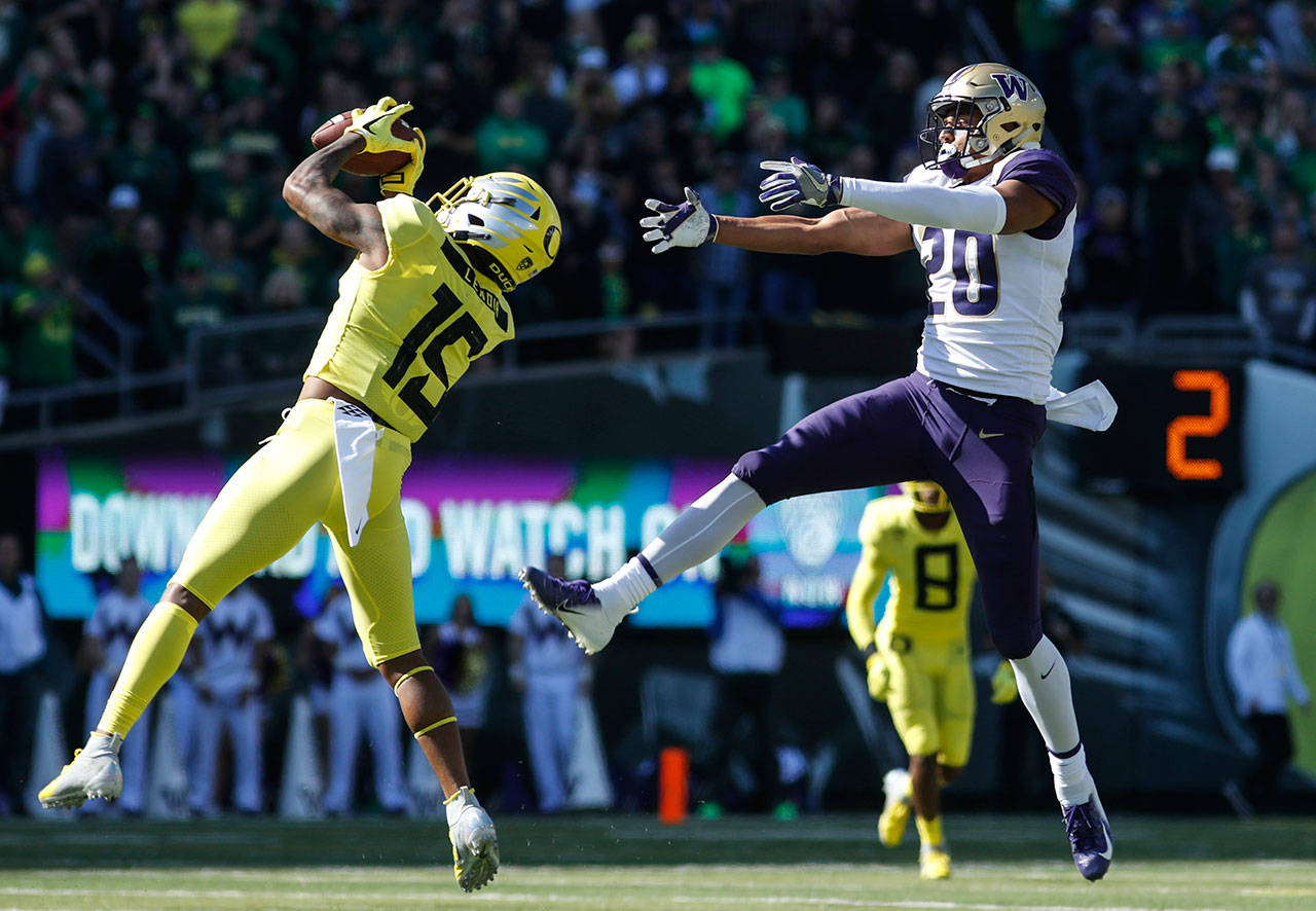 Oregon cornerback Deommodore Lenoir (15) intercepts a pass intended for Washington wide receiver Ty Jones (20) on Washington’s first drive during a game on Oct. 13, 2018, in Eugene, Ore. (AP Photo/Thomas Boyd)