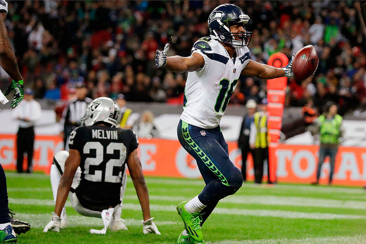 Seattle Seahawks wide receiver Tyler Lockett (16) celebrates after scoring a touchdown during the second half of Sunday’s NFL game against Oakland Raiders at Wembley stadium in London. (AP Photo/Matt Dunham)