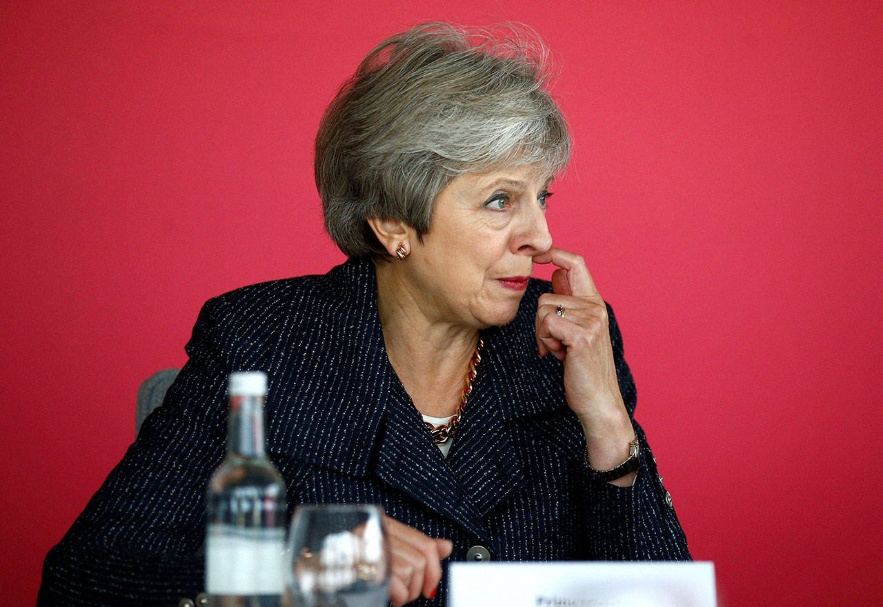 Britain’s Prime Minister Theresa May attends a roundtable meeting Thursday with business leaders whose companies are inaugural signatories of the Race at Work Charter at the Southbank Centre in London. (Henry Nicholls/Pool via AP)