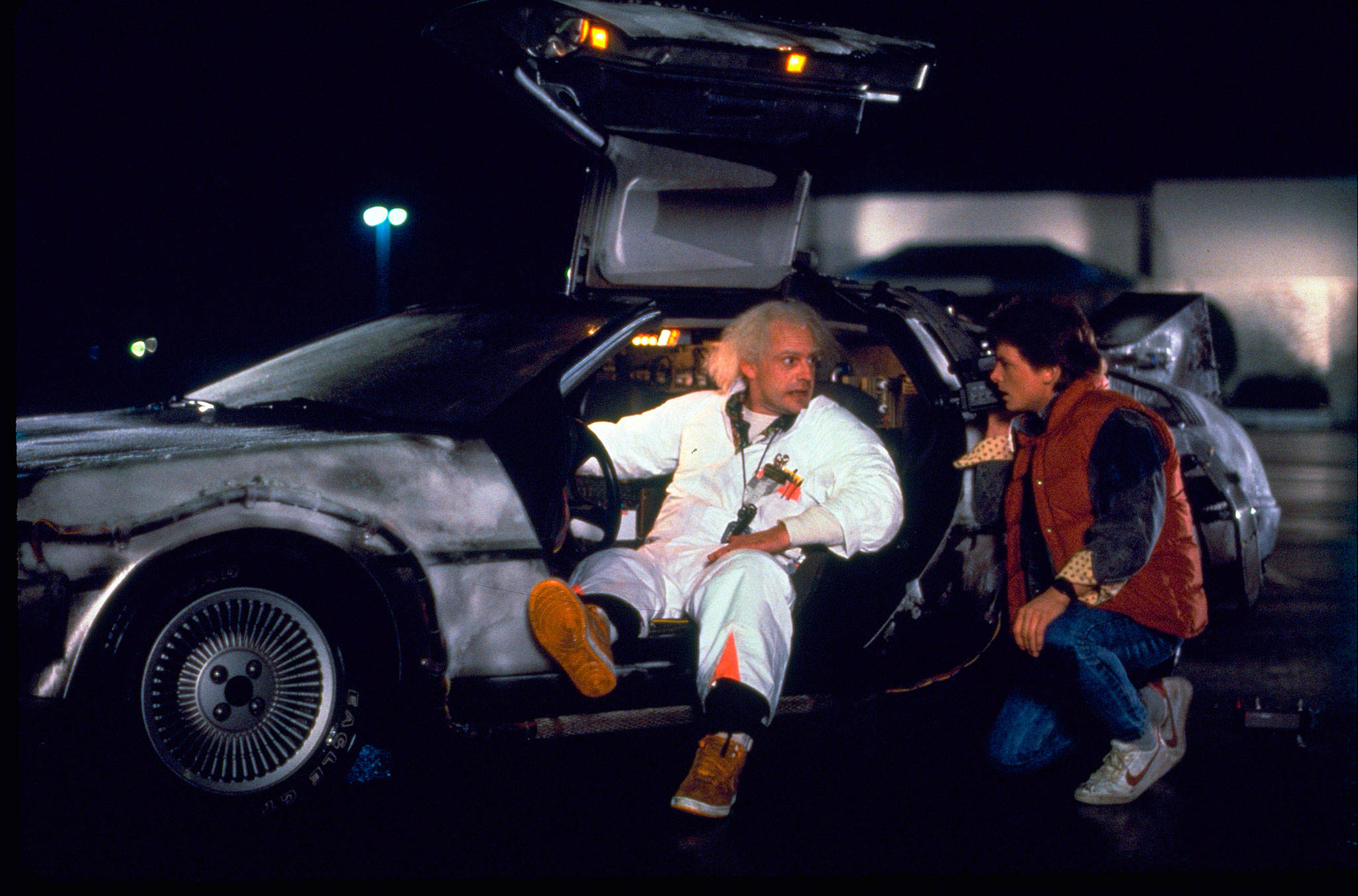 This photo provided by Universal Pictures Home Entertainment shows Christopher Lloyd, left, as Dr. Emmett Brown, and Michael J. Fox as Marty McFly in the 1985 film, “Back to the Future.” A federal court has dismissed a lawsuit brought by the widow of automaker John DeLorean over royalties stemming from the “Back to the Future” movies. Sally DeLorean claimed a Texas company using the DeLorean name had illegally accepted royalties from Universal Pictures for the promotional use of images of the iconic car. But a judge ruled Friday, Oct. 12, 2018, that a 2015 settlement agreement in a separate lawsuit over trademarks prohibited her from suing for the royalties. (Universal Pictures Home Entertainment via AP)
