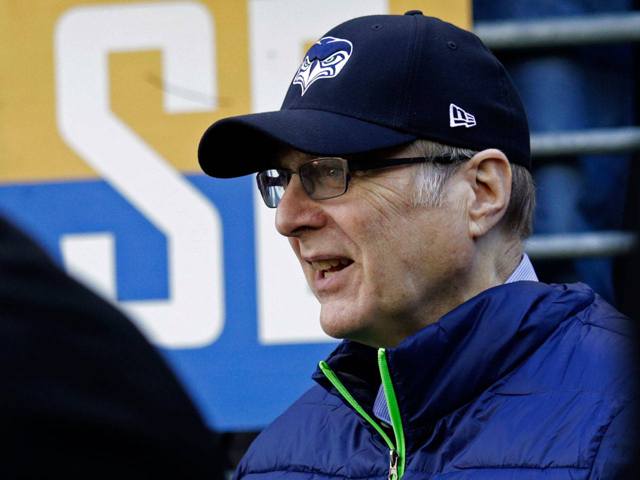 Seahawks owner Paul Allen stands near the field before a game against the Cardinals on Dec. 31, 2017, in Seattle. Allen, who co-founded Microsoft with his childhood friend Bill Gates before becoming a billionaire philanthropist who invested in conservation, space travel, arts and culture and professional sports, died Monday, Oct. 15, 2018. He was 65. (AP Photo/John Froschauer)
