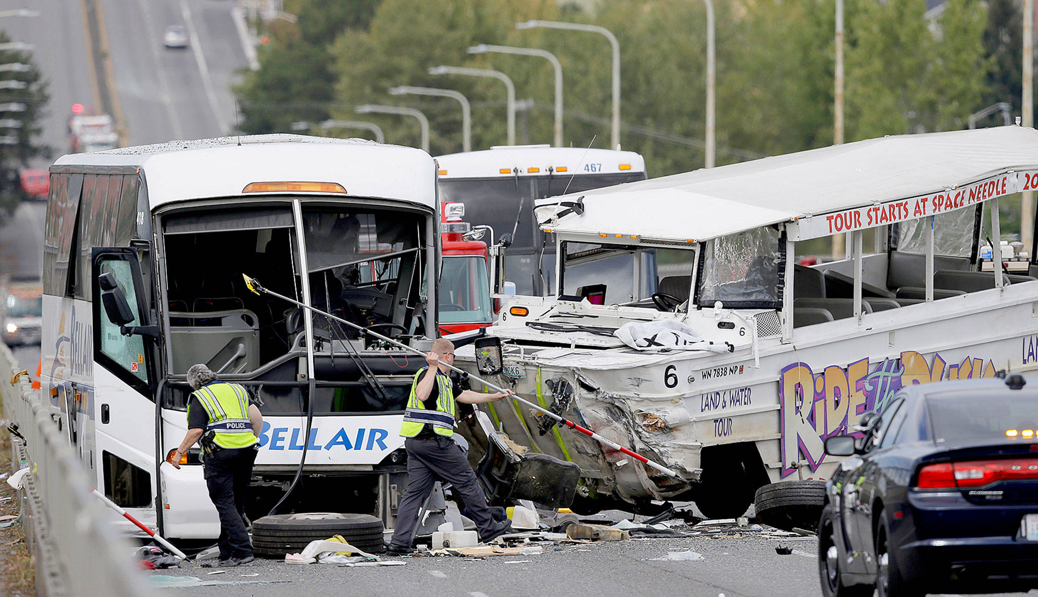 Seattle police work at the scene of a crash involving a “Ride the Ducks” amphibious, military-style tour vehicle (right) and a charter passenger bus that killed five people in 2015. (AP Photo/Ted S. Warren, File)
