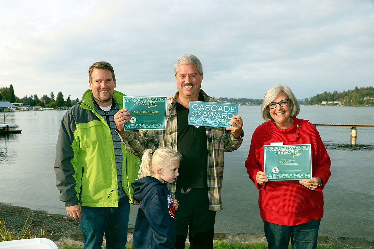 Snohomish County Council Member Sam Low (from left) congratulates Karl Slomchinski (with his granddaughter) on being named the inaugural 2018 Cascade Garden Award winner and Mary Fox on being named a finalist. (Snohomish Conservation District photo)