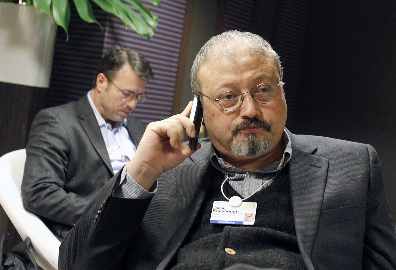 In this 2011 photo, Saudi journalist Jamal Khashoggi speaks on his cellphone at the World Economic Forum in Davos, Switzerland. Khashoggi was a Saudi insider who rubbed shoulders with the royal family. He was a close aide to the kingdom’s former spy chief and was a leading voice in the country’s prominent dailies. Khashoggi disappeared Oct. 2, 2018, after visiting his country’s consulate in Istanbul and may have been killed there. (AP Photo/Virginia Mayo, File)