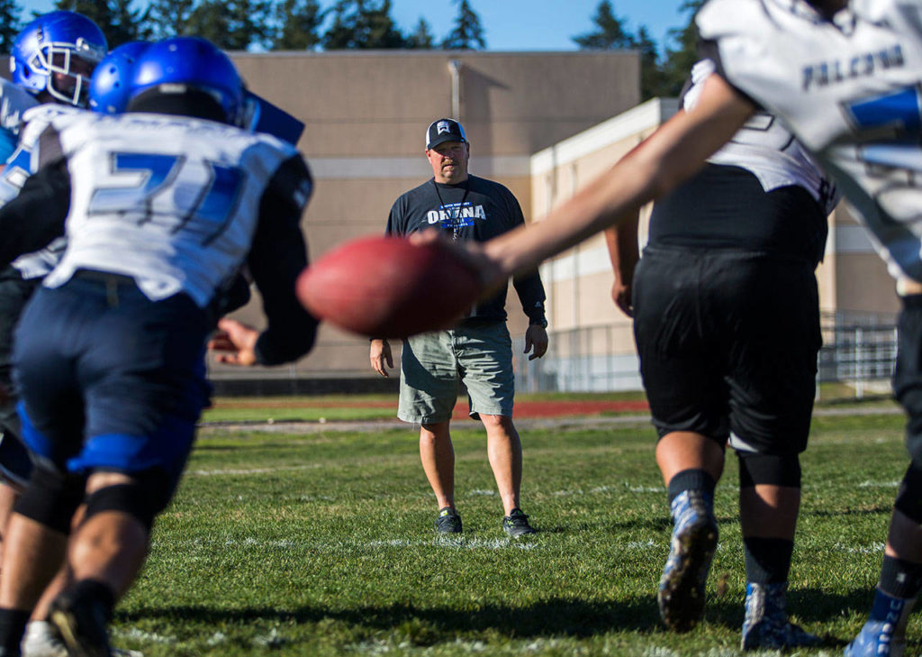 South Whidbey football coach Mark Hodson watches as his players run through a drill during a Tuesday practice session at South Whidbey High School in Langley. (Olivia Vanni / The Herald)
