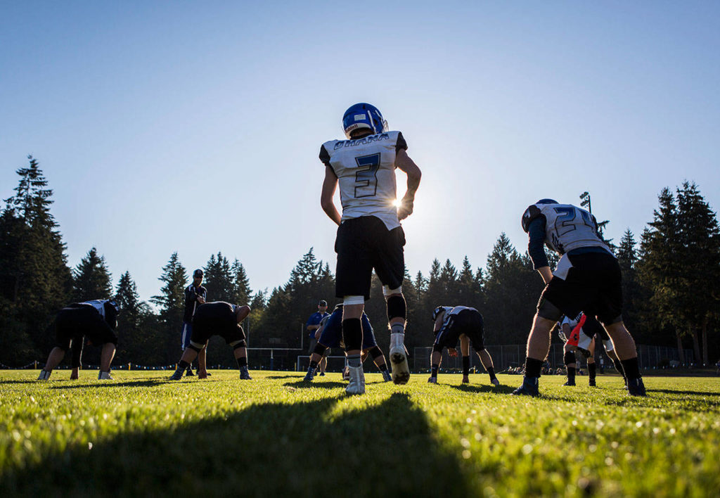 South Whidbey’s Kody Newman prepares to run a play during a Tuesday practice session at South Whidbey High School in Langley. (Olivia Vanni / The Herald). 
