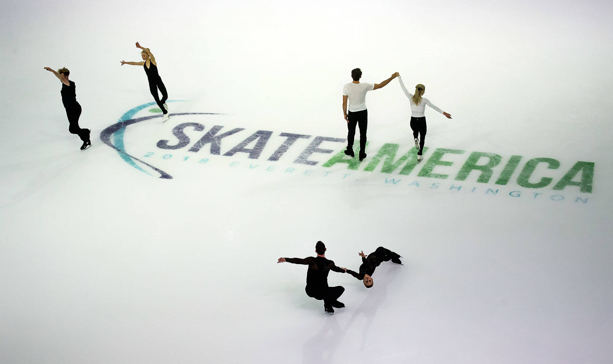 Pairs skaters (from left) Nica Digerness and Danny Neudecker (USA), Alexa Scimeca Knierim and Chris Knierim (USA), and Evelyn Walsh and Trennt Michaud (Canada) practice before the 2018 Skate America competition at Angel of the Winds Arena on Thursday in Everett. (Andy Bronson / The Herald)