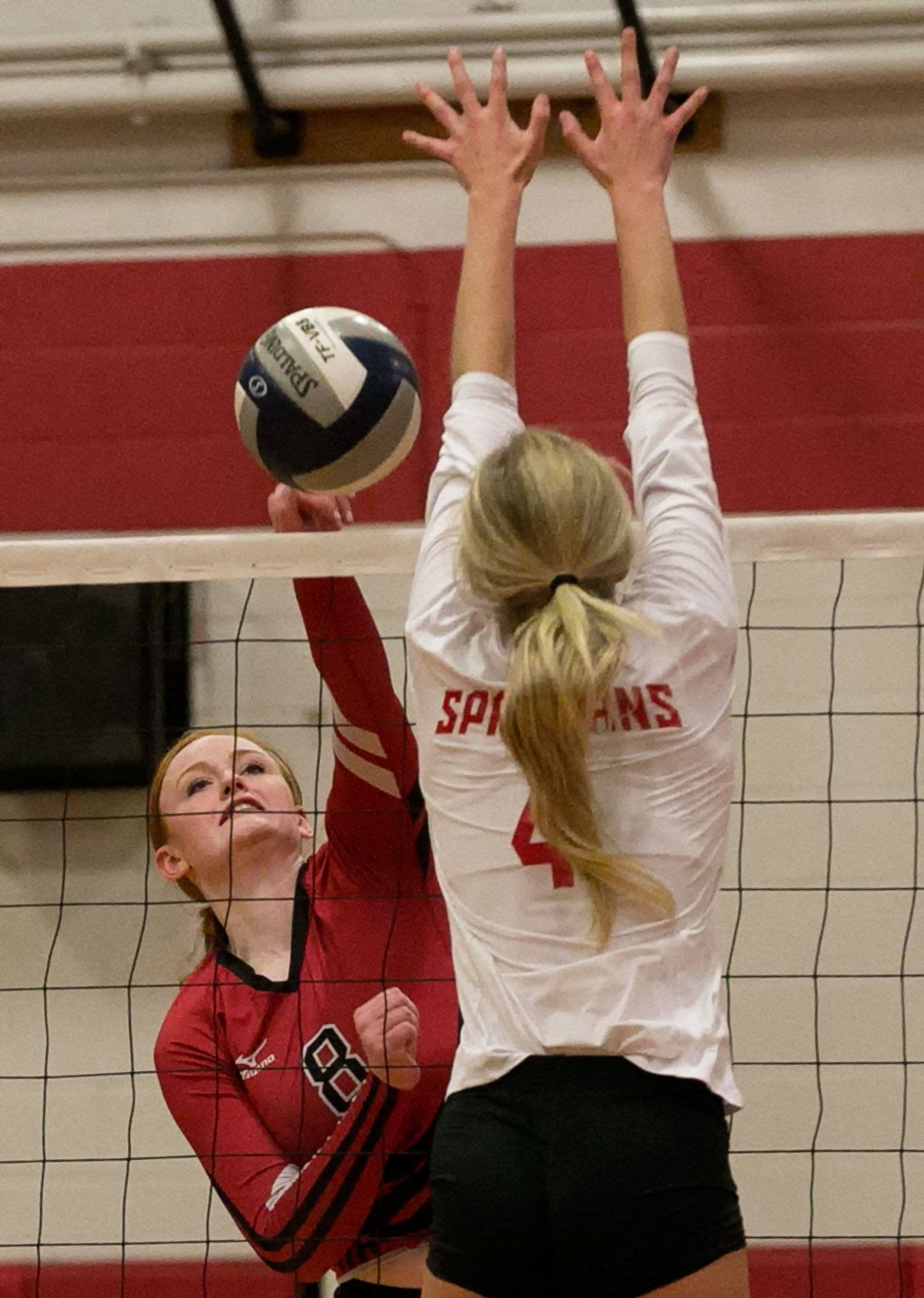 Snohomish’s Grace Raper attempts a kill past Stanwood’s Devon Martinka on Thursday at Stanwood High School. (Kevin Clark / The Herald)