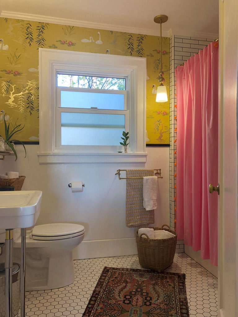 Bright colors from the wallpaper and shower curtain help add life to the more staid tile and fixtures in the remodeled bathroom. (Aaron Swaney)
