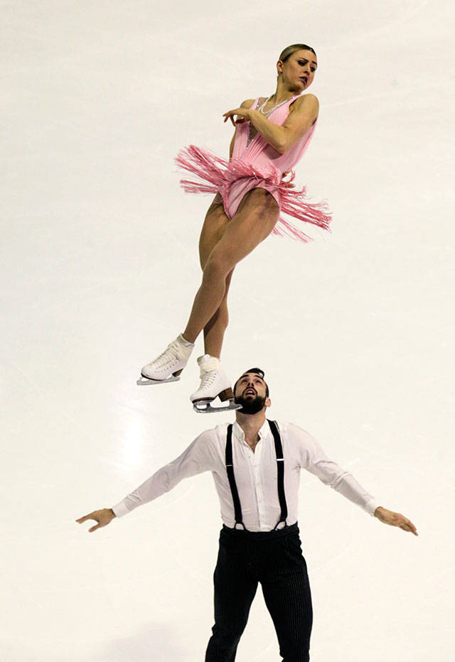 Ashley Cain and Timothy Leduc perform a triple twist loop during the pairs short program at the 2018 Skate America competition Friday at Angel of the Winds Arena in Everett. The 2018 Skate America is the first event in the 2018 ISU Grand Prix of Figure Skating Series. (Andy Bronson / The Herald)