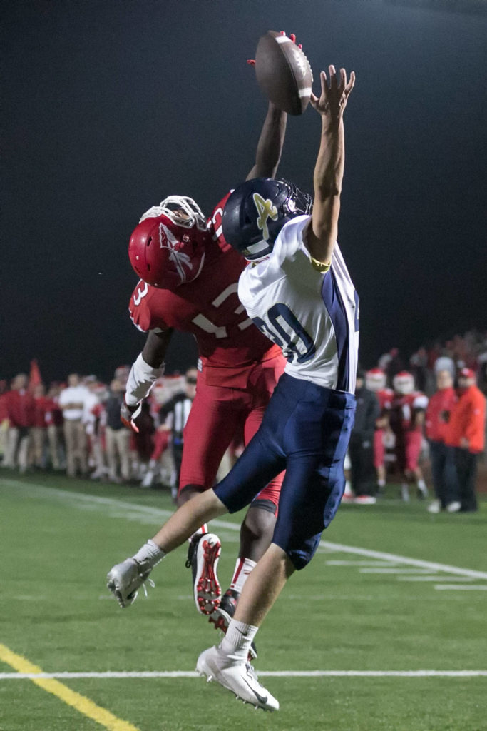 Marysville Pilchuck’s Bryan Sanders (left) attempts catch with Arlington’s Gavin Howell defending during a game on Oct. 19, 2018, at Quil Ceda Stadium in Marysville. (Kevin Clark / The Herald)
