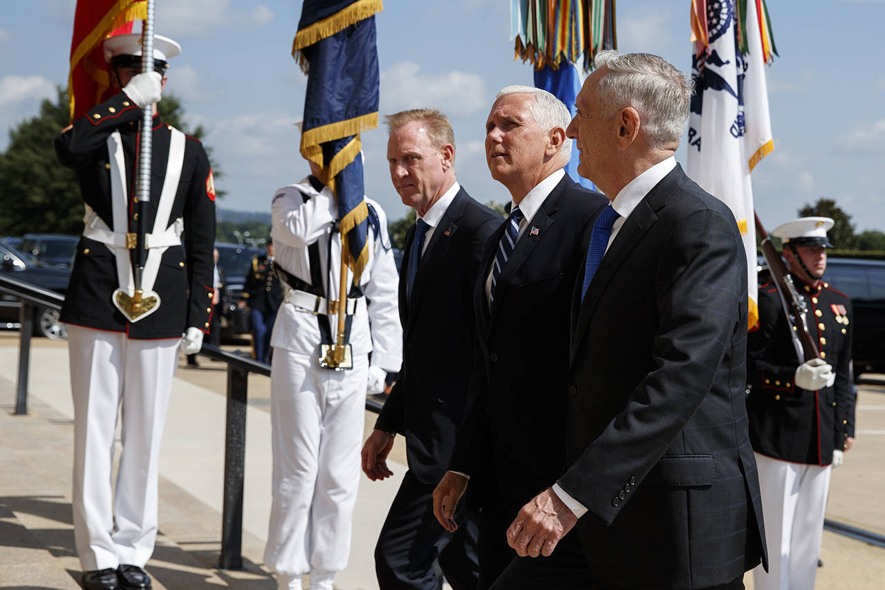 In this Aug. 9 photo, Vice President Mike Pence (center) is greeted by Deputy Secretary of Defense Pat Shanahan (left) and Secretary of Defense Jim Mattis before speaking at an event on the creation of a United States Space Force at the Pentagon. (AP Photo/Evan Vucci)