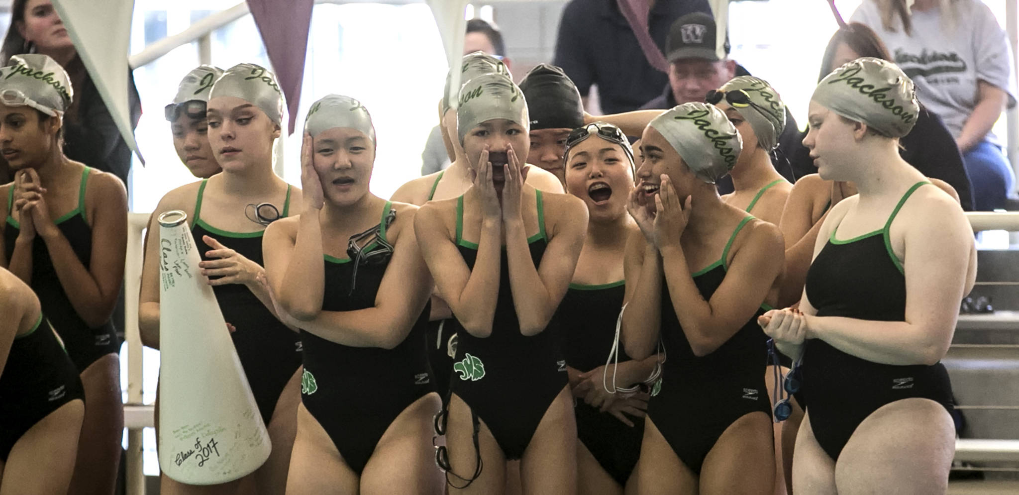 Jackson swimmers cheer on their teammates during a dual meet against Kamiak on Oct. 18 at Kamiak High School in Mukilteo. (Kevin Clark / The Herald)