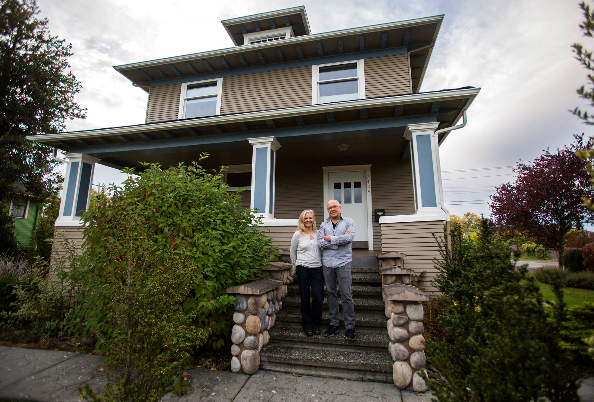 Melissa Barrett and Daniel Cardenas stand in front of their Riverside neighborhood home in Everett. Their house won one of this year’s Monte Cristo Awards. (Olivia Vanni / The Herald)