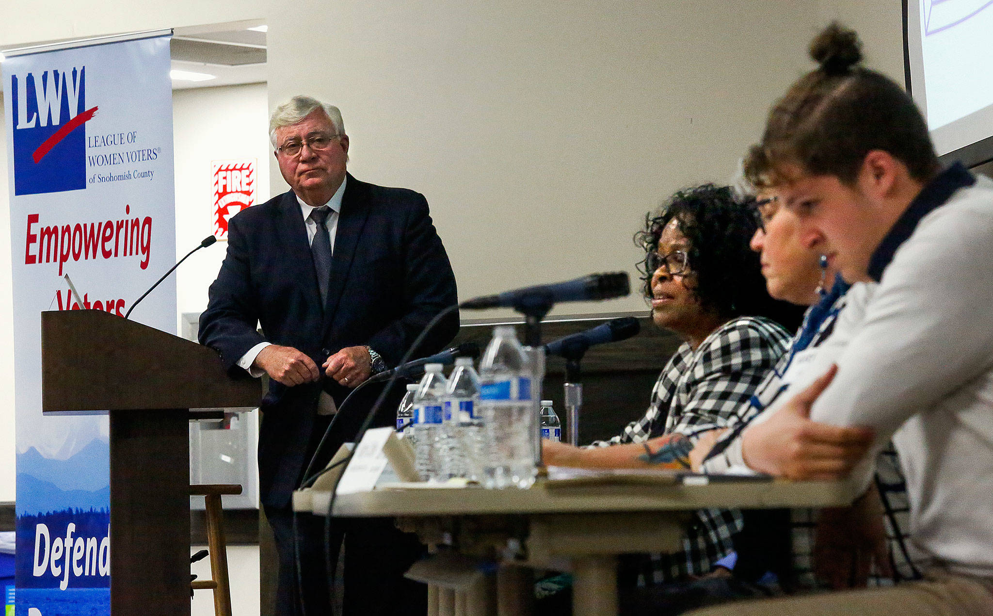 While emcee Bob Drewel and panelists Cameron Calder (right) and Kathy Coffey listen, panelist Janice Green (center) speaks Wednesday night at the League of Women Voters of Snohomish County’s Civil Discourse Forum held in the Wilderness Room of the Jackson Center at EvCC. (Dan Bates / The Herald)