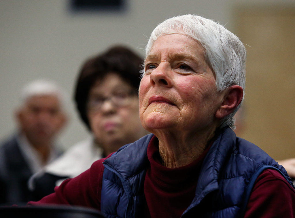League of Women Voters member Julie Langabeer of Everett listens intently Wednesday night during the Civil Discourse Forum in the Wilderness Room at EvCC. The weight of the topics could be felt throughout the room and seen on faces. (Dan Bates / The Herald)
