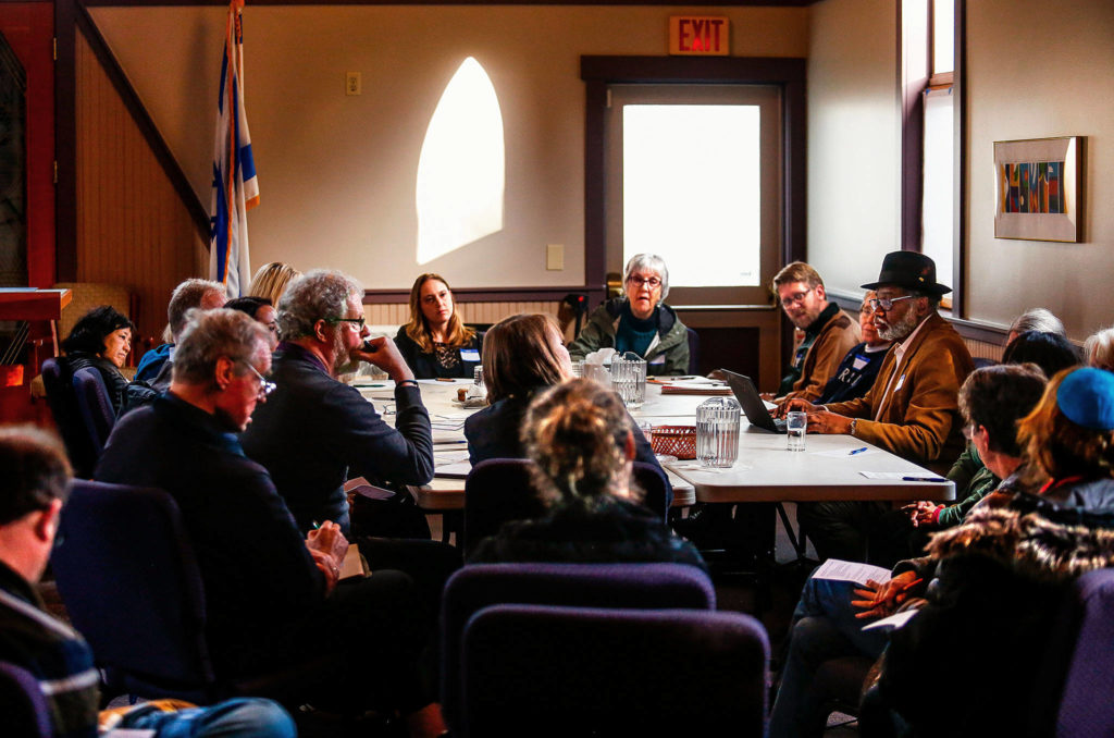 Rabbi Rachel Kort (far end, left) and the Rev. Carol Jenson lead discussion at a gathering at Everett’s Temple Beth Or Monday to talk about a vigil in response to the weekend’s horrific killings in Pittsburgh. The meeting drew a good number of participants, including from area faith groups. (Dan Bates / The Herald)
