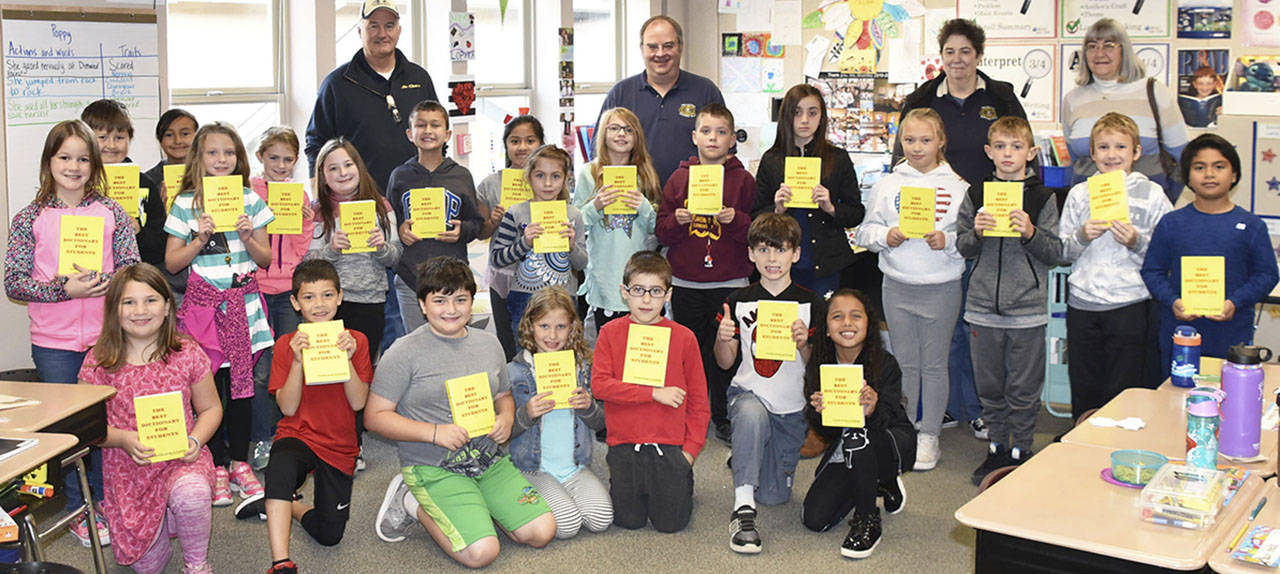Third-grade students in Lindsay Lopata’s class at Pioneer Elementary School in Arlington show off the dictionaries they received from Arlington Kiwanis. (Contributed photo)