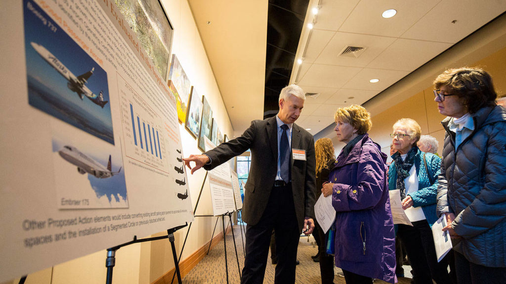 Steve Alverson, of Environmental Science Associates, explains the comparison of airplanes that will be landing at Paine Field to Marjie Field prior to a Federal Aviation Administration hearing at the Lynnwood Convention Center on Monday. (Andy Bronson / The Herald)

