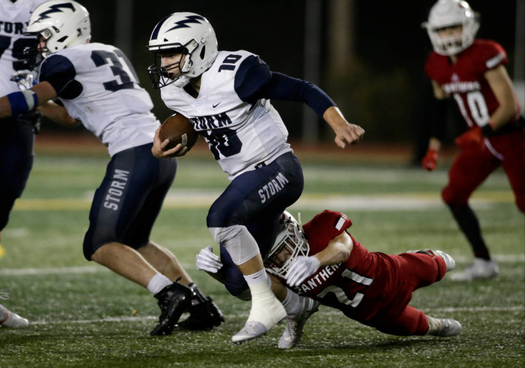 Snohomish’s Tyler Massena takes down Squalicum’s Spencer Lloyd for a loss during the Panthers’ 30-27 win Fridayat Veterans Memorial Stadium in Snohomish. (Andy Bronson / The Herald)
