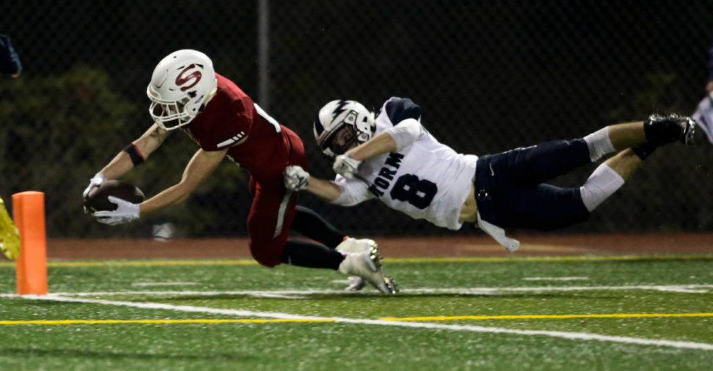 Squalicum’s Declan McGhee (right) tackles Snohomish’s Tyler Massena just short of the end zone during the Panthers’ 30-27 win Fridayat Veterans Memorial Stadium in Snohomish. (Andy Bronson / The Herald)
