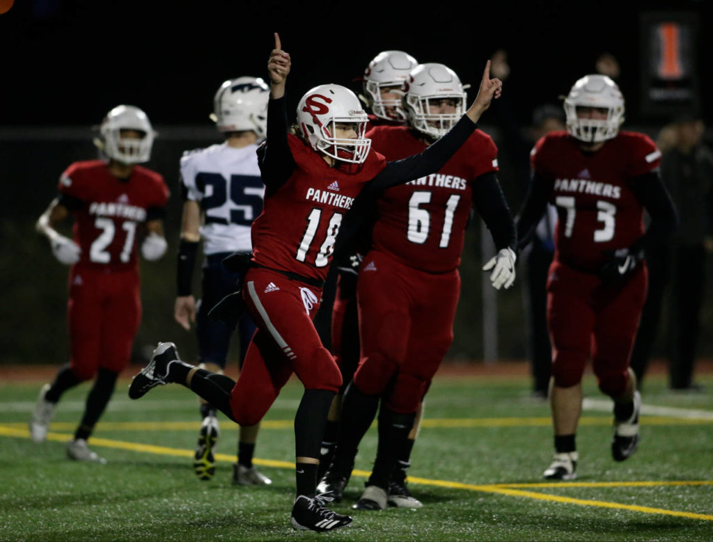 Snohomish’s Tayte Conover (18) throws up his arms after scoring on a quarterback keeper during the Panthers’ 30-27 win over Squalicum on Fridayat Veterans Memorial Stadium in Snohomish. (Andy Bronson / The Herald)
