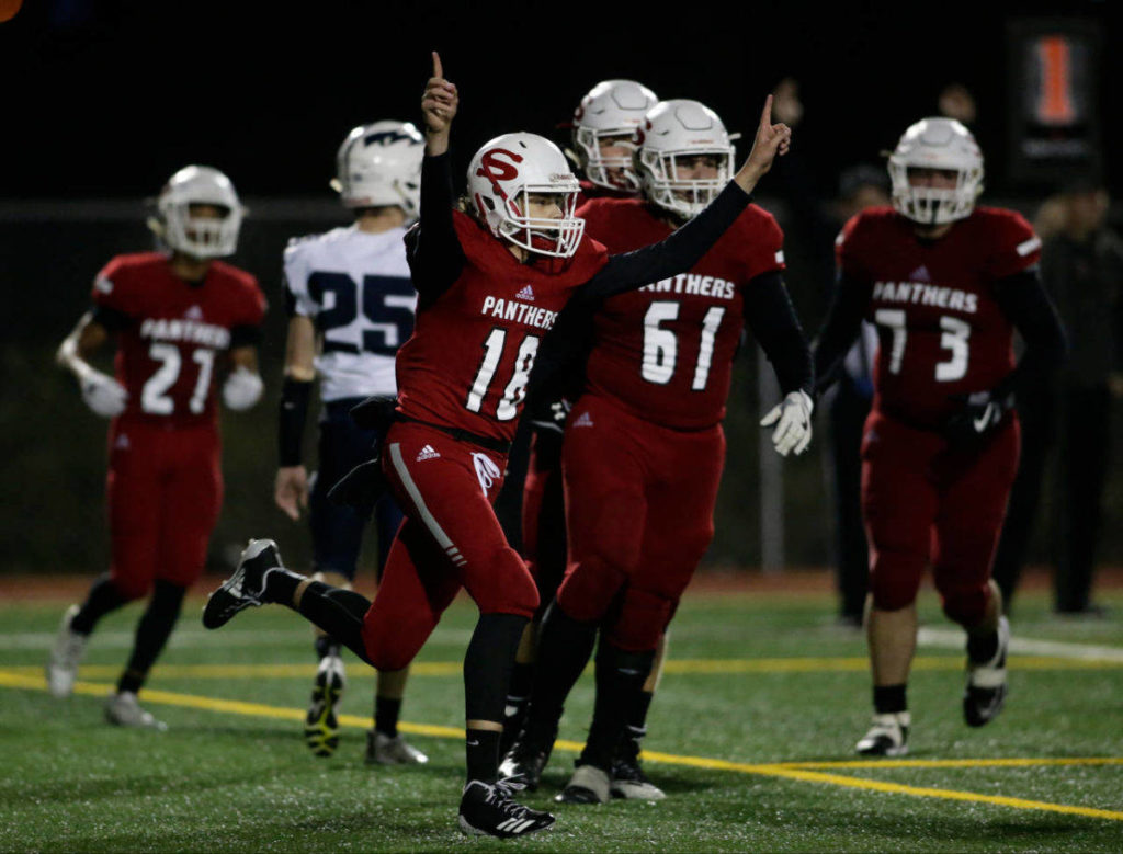 Snohomish’s Tayte Conover (18) throws up his arms after scoring on a quarterback keeper during the Panthers’ 30-27 win over Squalicum on Friday night at Veterans Memorial Stadium in Snohomish. (Andy Bronson / The Herald)
