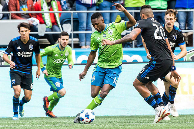 Seattle Sounders defender Kelvin Leerdam (center) maneuvers around San Jose Earthquakes midfielder Anibal Godoy in the first half of an MLS soccer game Sunday in Seattle. (Bettina Hansen/The Seattle Times via AP) 
