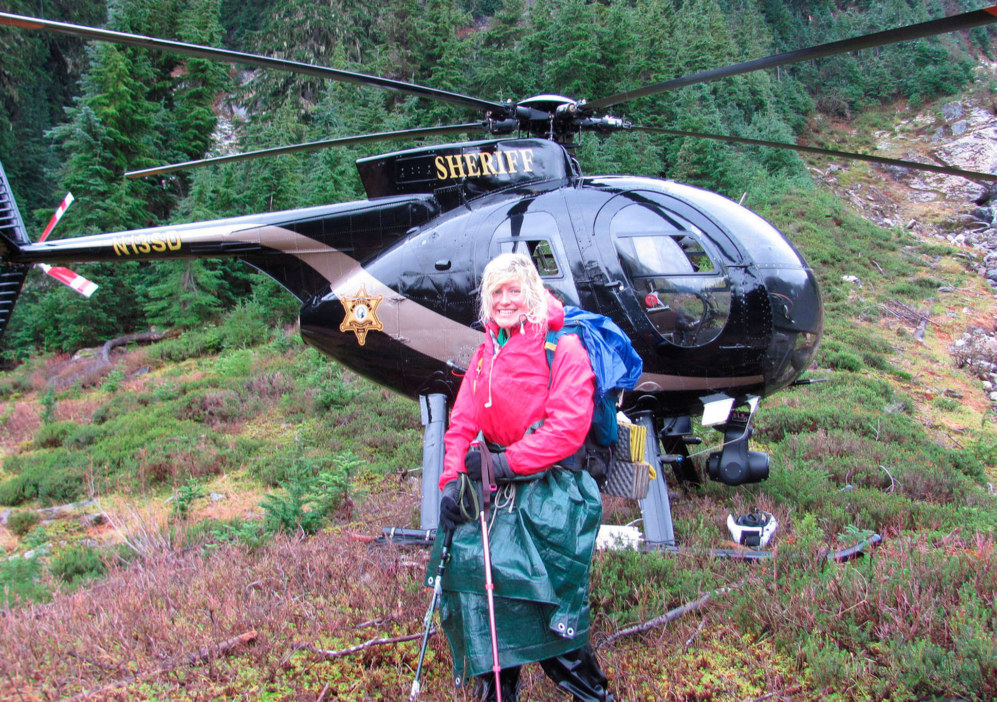 Katharina Groene, of Munich, Germany, with a Snohomish County Sheriff’s Office helicopter after her rescue on Monday near Mica Lake on the Pacific Crest Trail in the Glacier Peak Wilderness. (Provided by Katharina Groene)