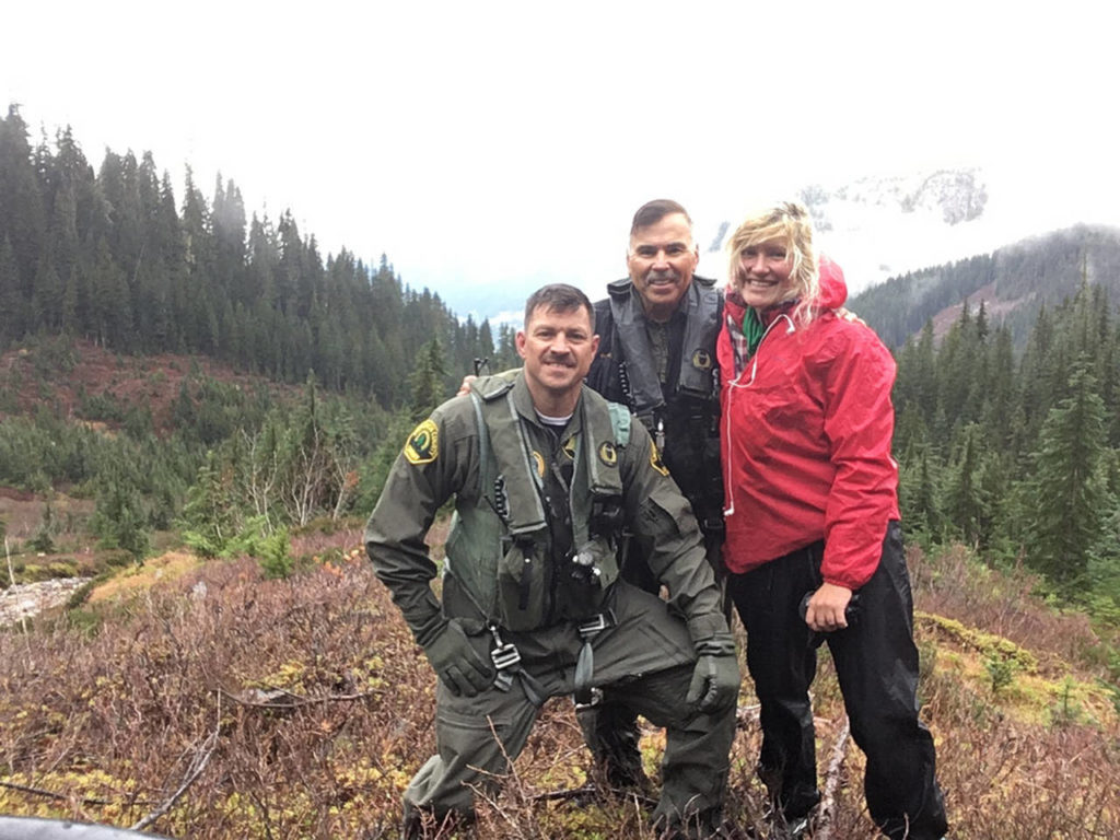 The Snohomish County Sheriff’s Office helicopter crew and Katharina Groene, of Munich, Germany, whom they rescued on Monday near Mica Lake in the Glacier Peak Wilderness. From left: pilot Einar Espeland, Chief Pilot Bill Quistorf and Groene. (Provided by Katharina Groene) 
