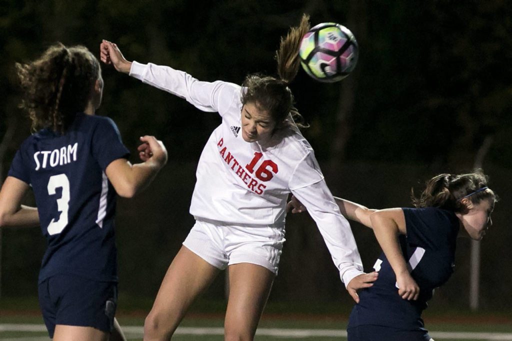 Snohomish’s Taylor Khorrami (16) heads in a goal with Squalicum’s Audra Johnson (left) and Jamie Dierdorff defending during a 3A Northwest District 1 Tournament game against on Oct. 30, 2018, at Shoreline Stadium. (Kevin Clark / The Herald)
