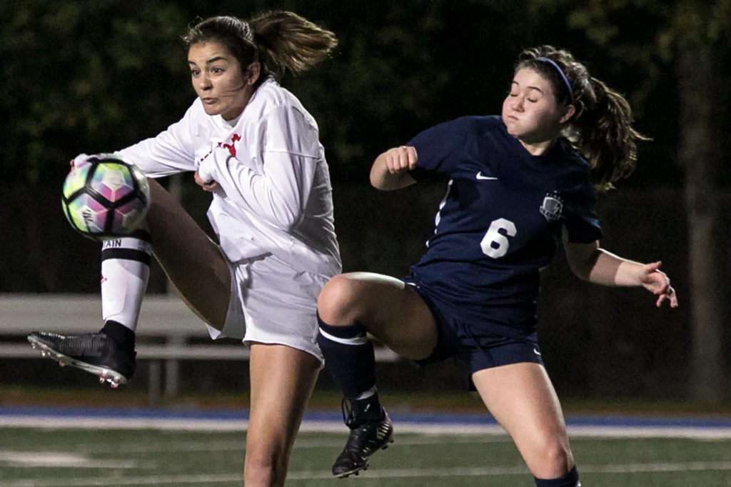 Snohomish’s Taylor Khorrami (left) works to control the ball with with Squalicum’s Jamie Dierdorff defending during a 3A Northwest District 1 Tournament game on Oct. 30, 2018, at Shoreline Stadium. (Kevin Clark / The Herald)
