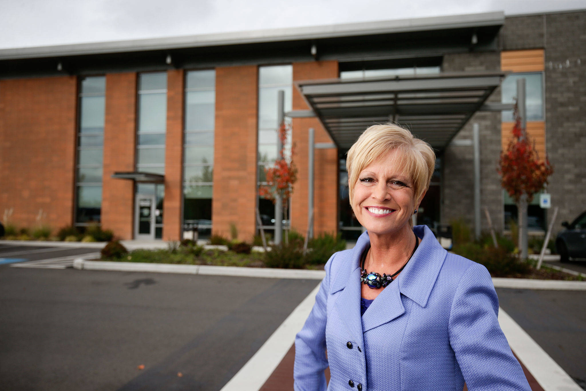 CEO Sally Anne Schneider in front of Smokey Point Behavioral Hospital in Marysville. (Andy Bronson / The Herald)