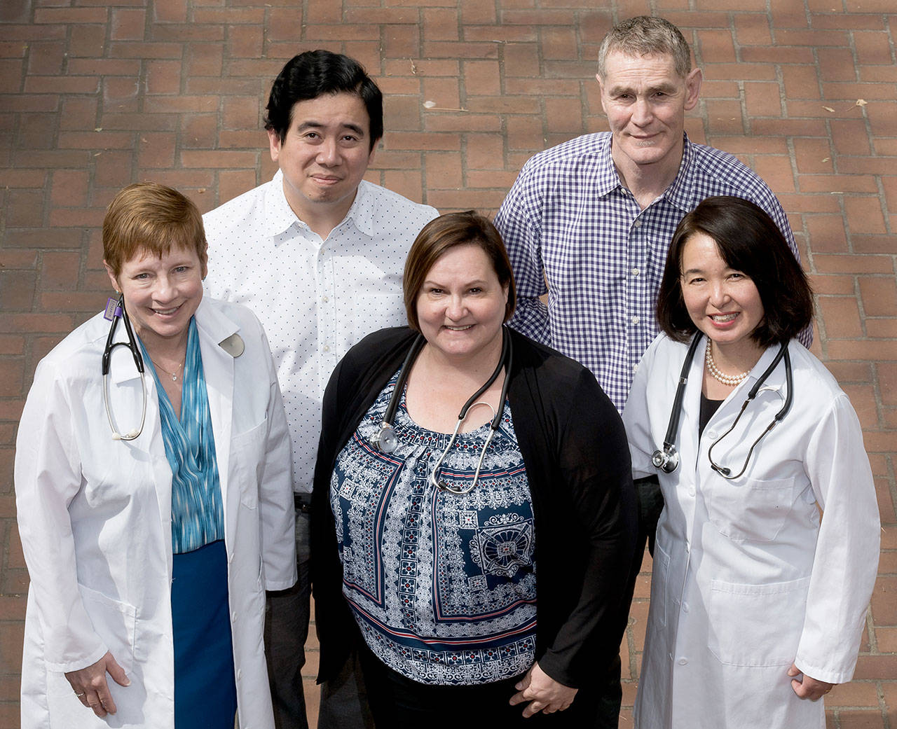 These doctors will participate in a Seattle clinic of the Undiagnosed Diseases Network. From left: Dr. Gail Jarvik, head of medical genetics at the University of Washington School of Medicine; Dr. Sirisak Chanprasert, assistant professor of medicine at UW; Dr. Katrina Dipple, head of genetic medicine at the UW Medicine Department of Pediatrics; Dr. Ian Glass, professor of pediatrics at UW, who practices at Seattle Children’s Hospital; and Dr. Fuki Hisama, professor of medicine at UW. (UW Medicine)