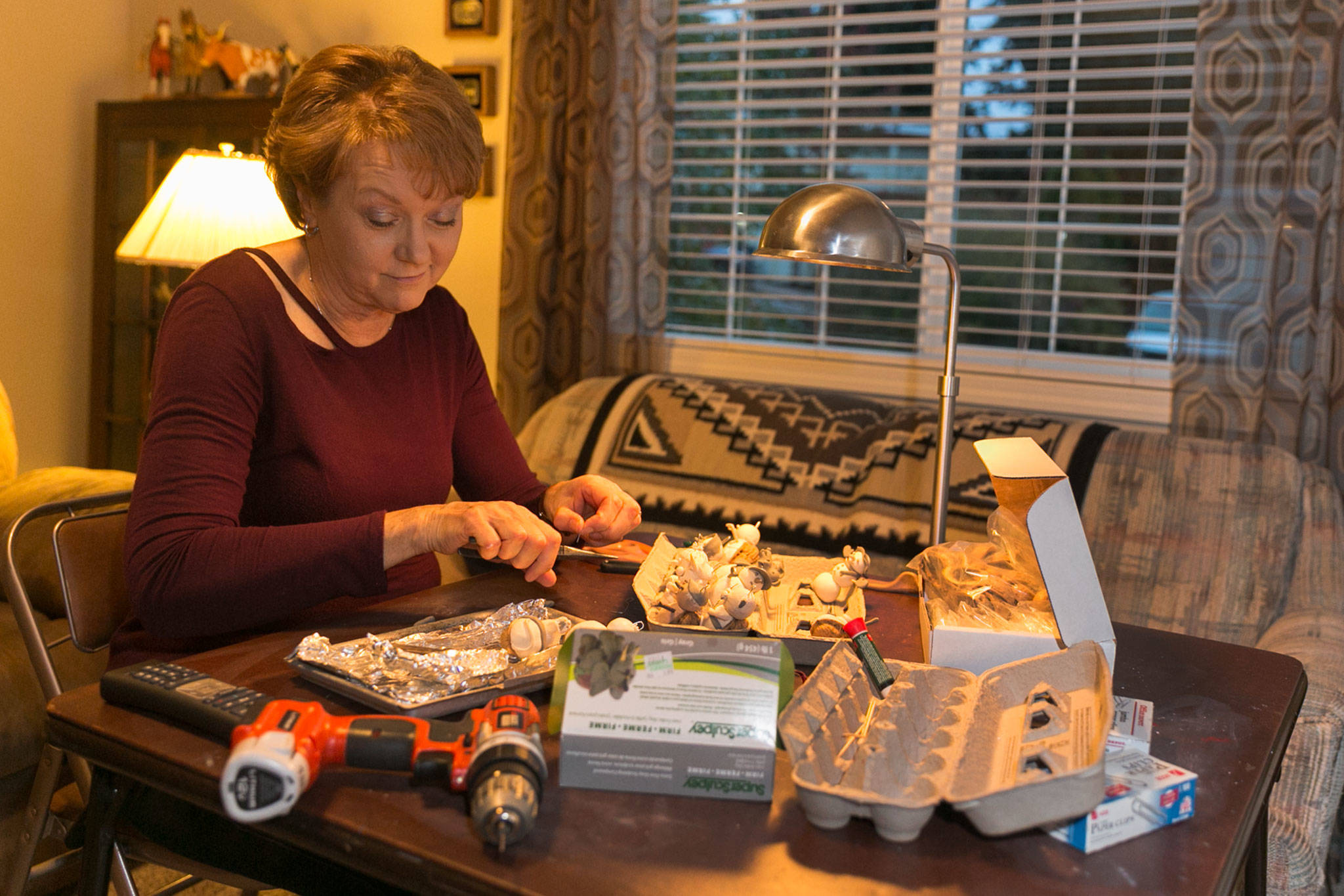Caralee Hudson works on her ornaments at her home in Lynnwood. (Kevin Clark / The Herald)