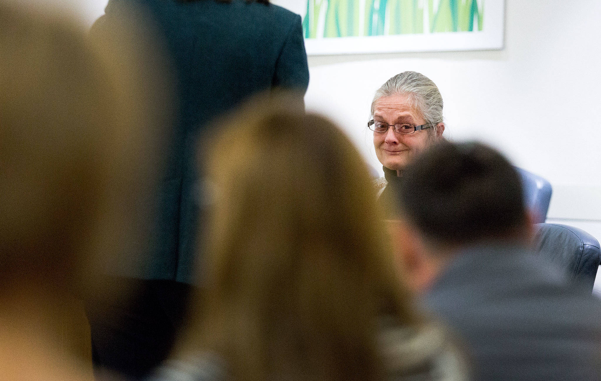 Lorri Arnett, 55, looks toward the victims’ family and her own family at the Snohomish County Courthouse in Everett on Monday. She was sentenced to 10½ years in prison for vehicular homicide. (Andy Bronson / The Herald)