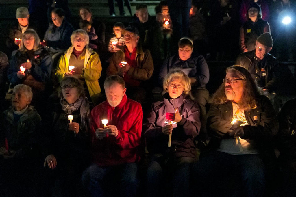 Citizens gather for the interfaith candlelight vigil Thursday night. (Kevin Clark / The Herald)
