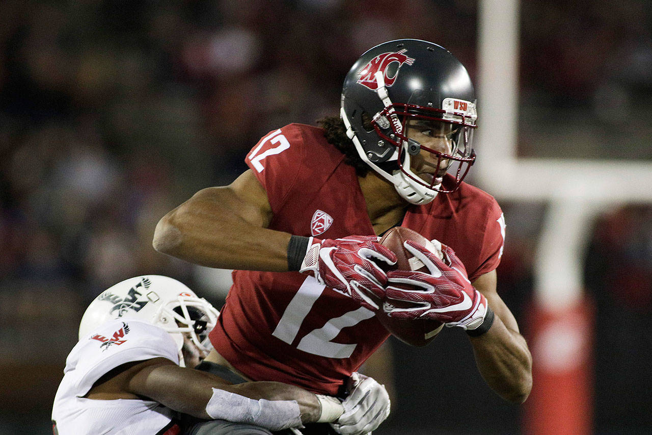 Eastern Washington defensive back D’londo Tucker (left) tackles Washington State wide receiver Dezmon Patmon (12) during a game in Pullman on Sept. 15. (Young Kwak / Associated Press)