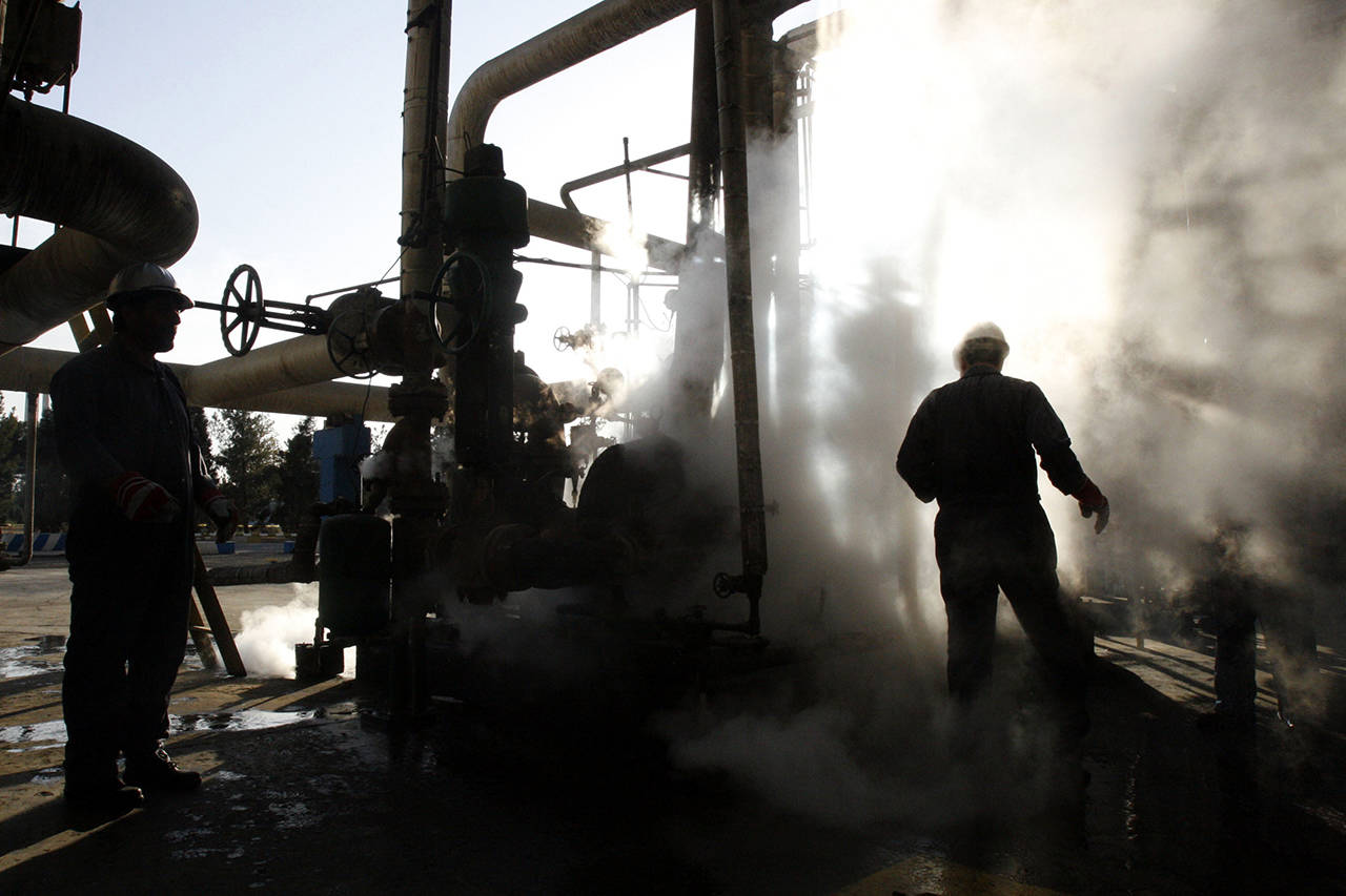 In this 2007 photo, a worker repairs a part of a unit of the Tehran oil refinery, in Tehran, Iran. The country is preparing for the return of U.S. sanctions Nov. 5 that will hit its multi-billion dollar oil exports. (AP Photo/Vahid Salemi, File)