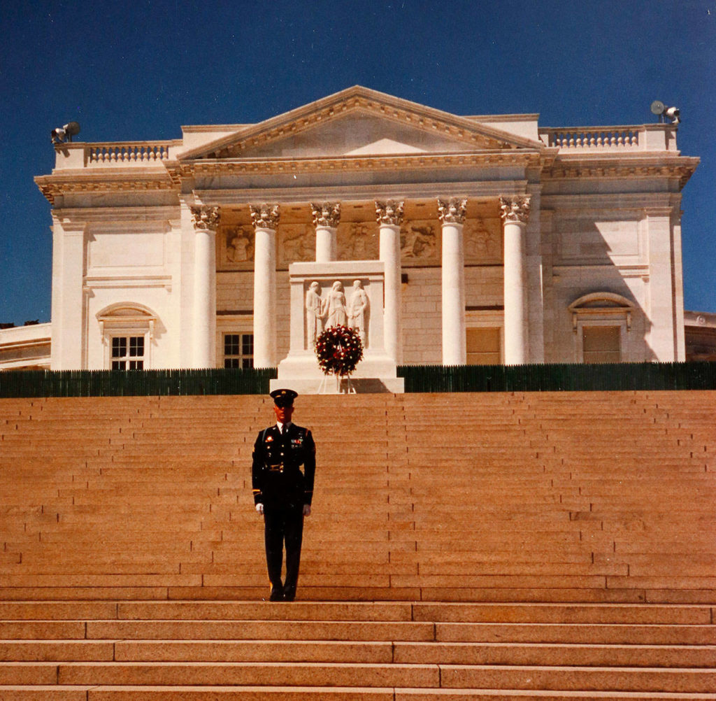 As a Tomb Guard, Jason Biermann stands before the Tomb of the Unknown Soldier with the Memorial Amphitheater in the background at Arlington National Cemetery. (Dan Bates / The Herald)
