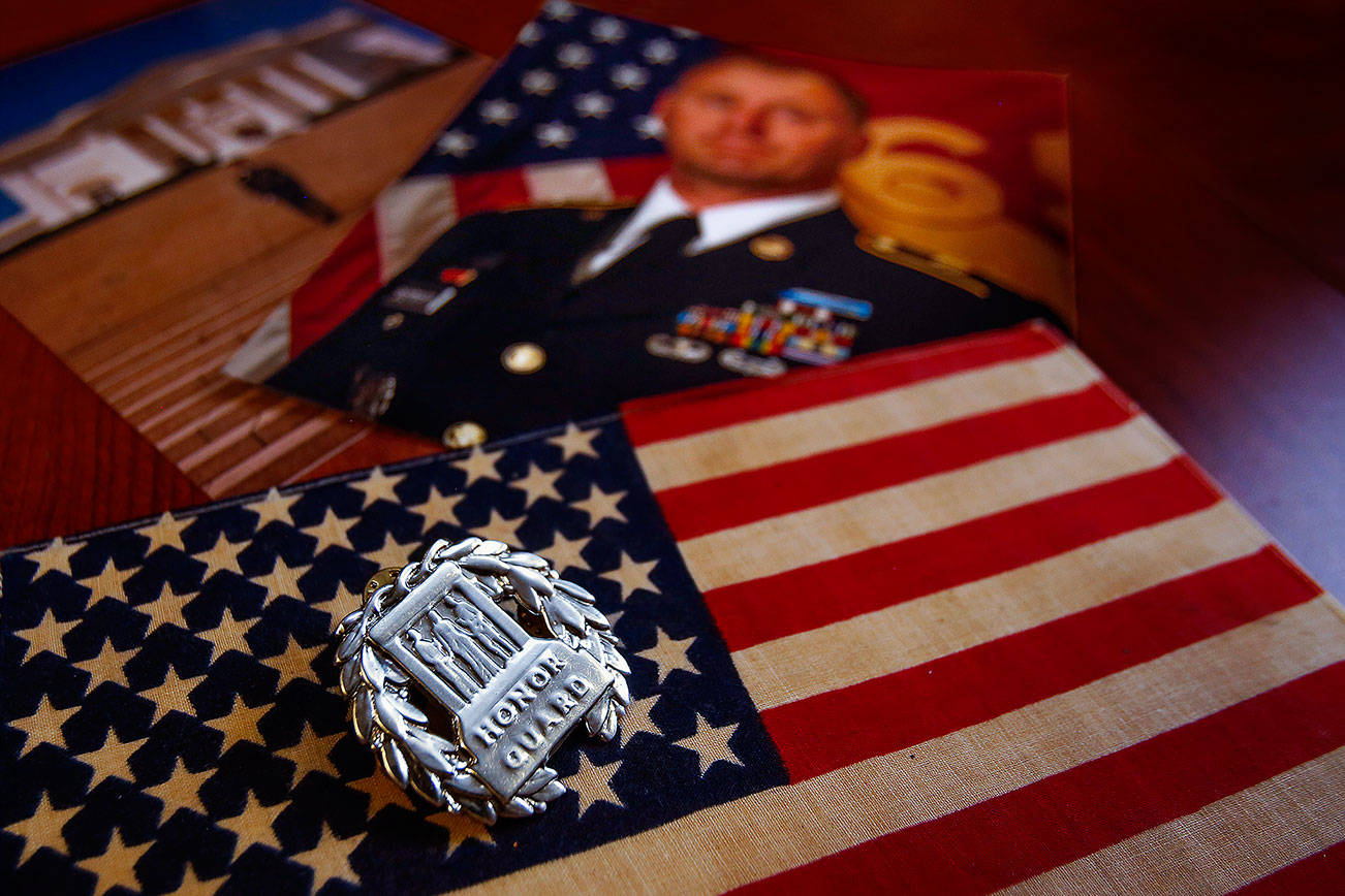 Army veteran Jason Biermann, now director of Snohomish County Department of Emergency Management, was once part of the Honor Guard for the Tomb of the Unknown Soldier. The sterling silver badge is worn down from the constant polishing Biermann did to make sure it shined brightly on his uniform. (Dan Bates / The Herald)