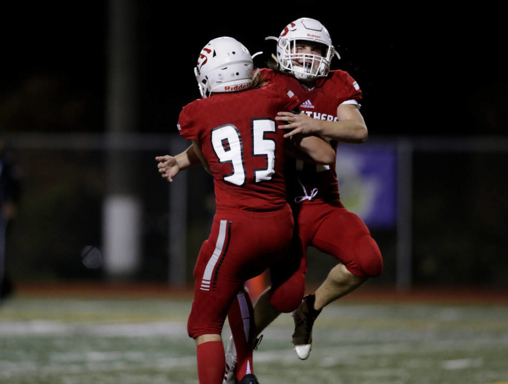 Snohomish’s Noah Dunham (95) is congratulated by teammate Ryan Douglas after a touchdown during a Week 10 playoff game against Garfield on Nov. 2, 2018, at Veterans Memorial Stadium in Snohomish. Snohomish won 42-35. (Andy Bronson / The Herald)
