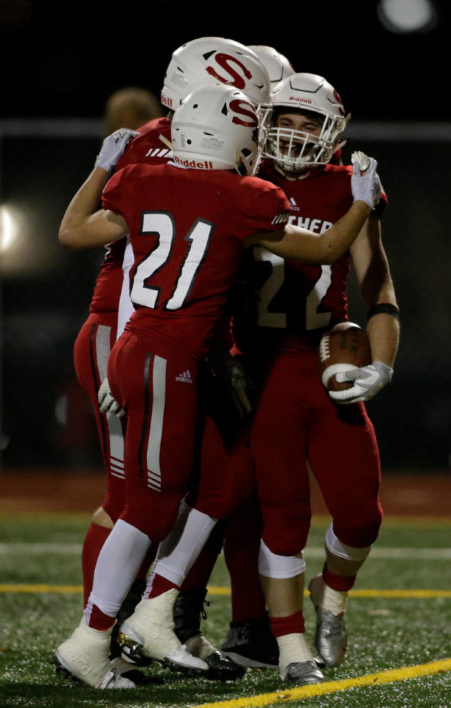 Snohomish’s Tyler Larson (22) is congratulated by teammates after a touchdown during a Week 10 playoff game against Garfield on Nov. 2, 2018, at Veterans Memorial Stadium in Snohomish. Snohomish won 42-35. (Andy Bronson / The Herald)
